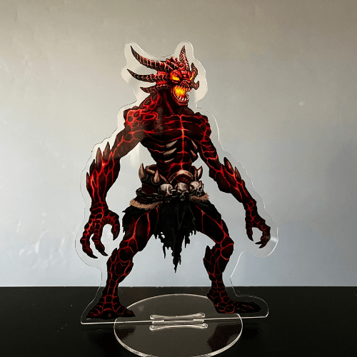Demon figure on clear stand, red and black coloring, horns, claws, glowing eyes.