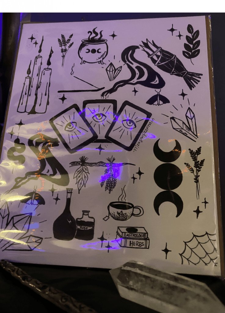 Black temporary tattoos with occult symbols: tarot cards, snake, potion bottles, crystals.