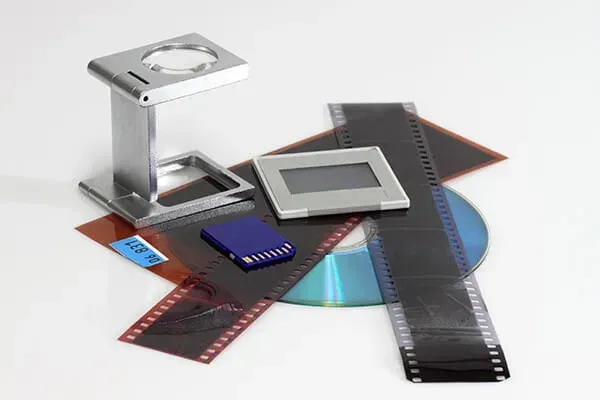 a person is holding a roll of film in their hand .