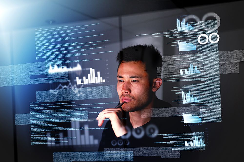a man in a black shirt is looking at a computer screen