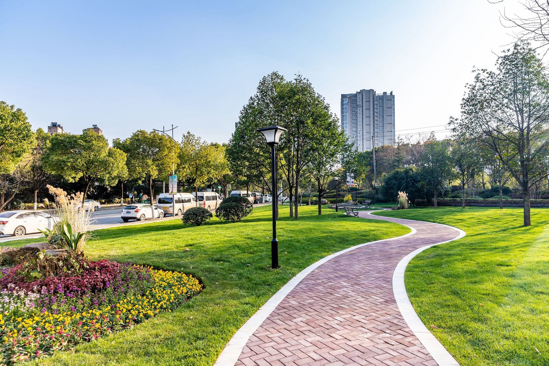 Beautifully maintained commercial landscape featuring colorful planting beds, trimmed shrubs, and clean walkways at a business park in Macomb MI