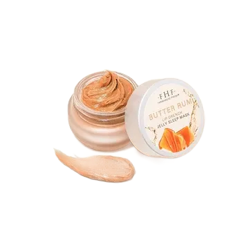 Open jar of peach-colored butter cream with lid beside it and a swipe of product on a white background