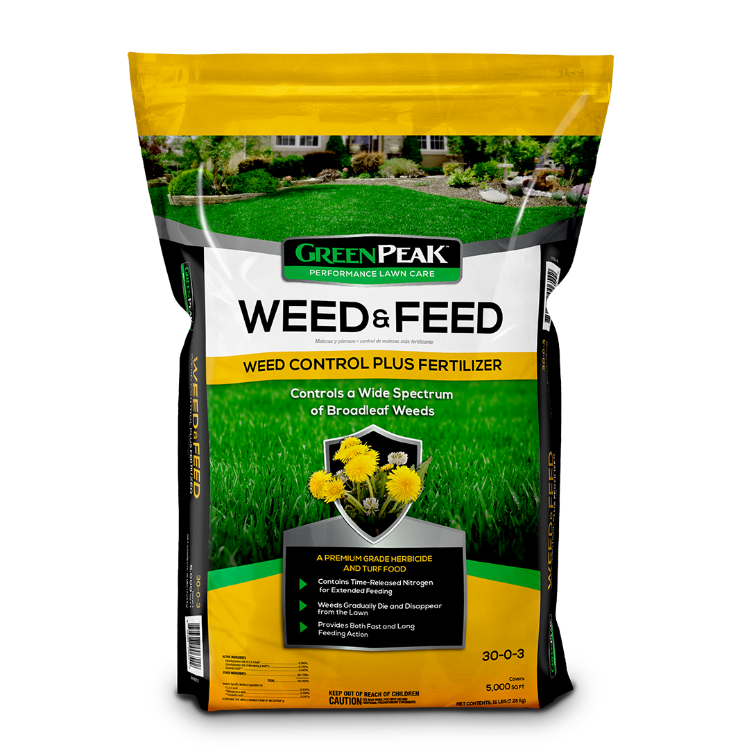 A yellow, white, and black bag of green peak weed and feed on a white background.