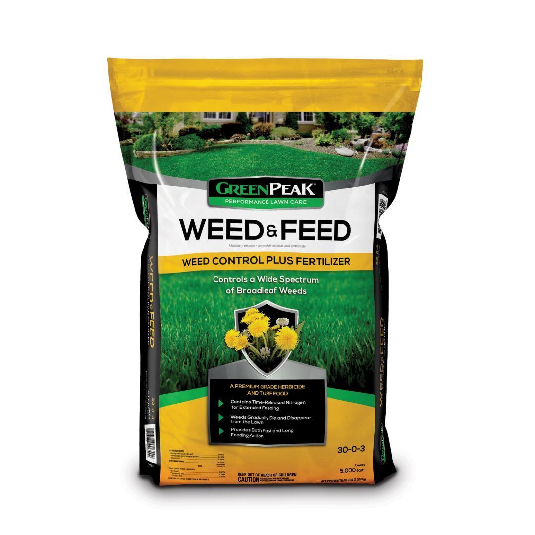 A bag of green peak weed & feed on a white background.