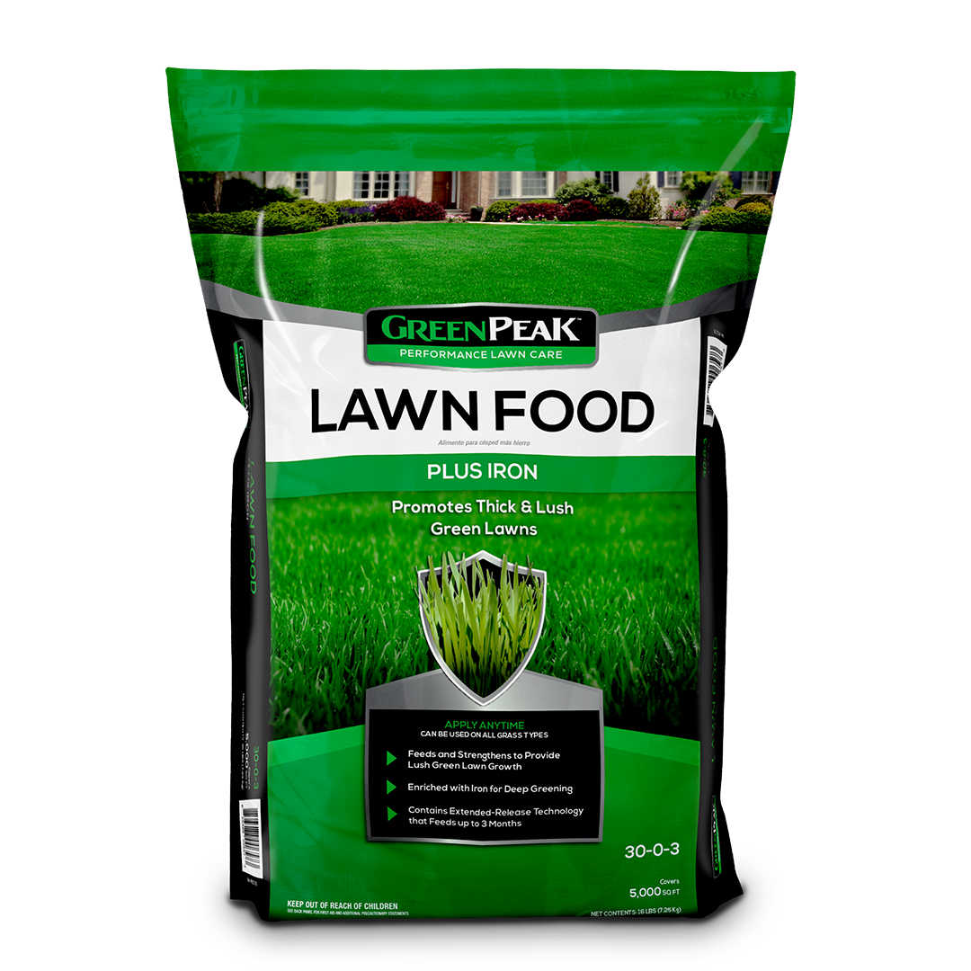 A green, black, and white bag of green peak lawn food plus iron on a white background