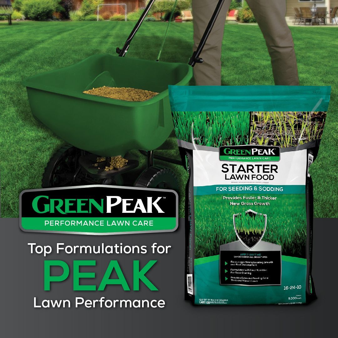A person is spreading green peak starter lawn food on a lush green lawn