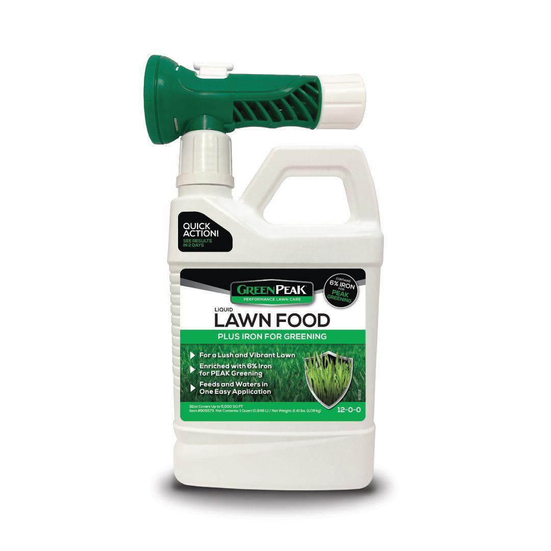 A bottle of greenpeak lawn food with a sprayer attached to it.