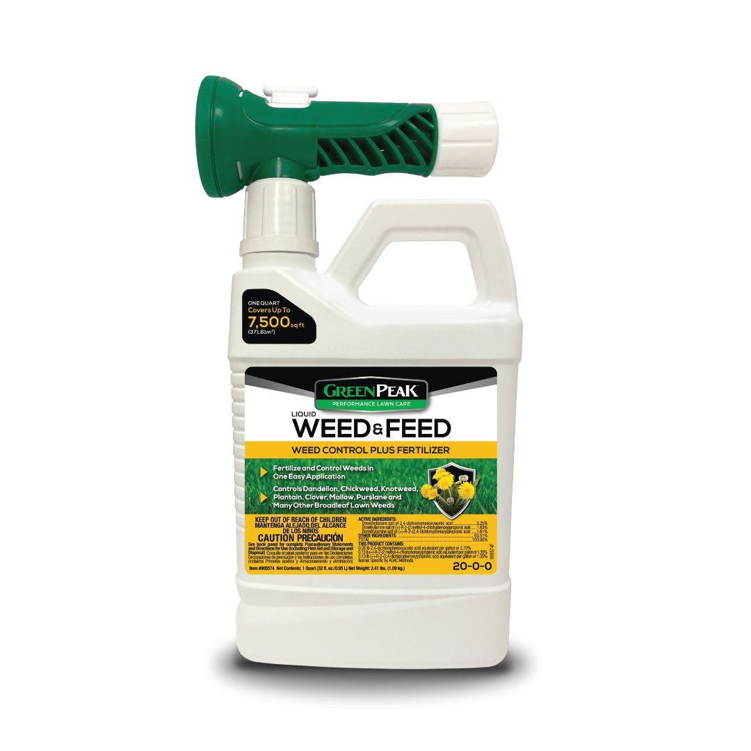 A bottle of weed and feed with a sprayer attached to it.