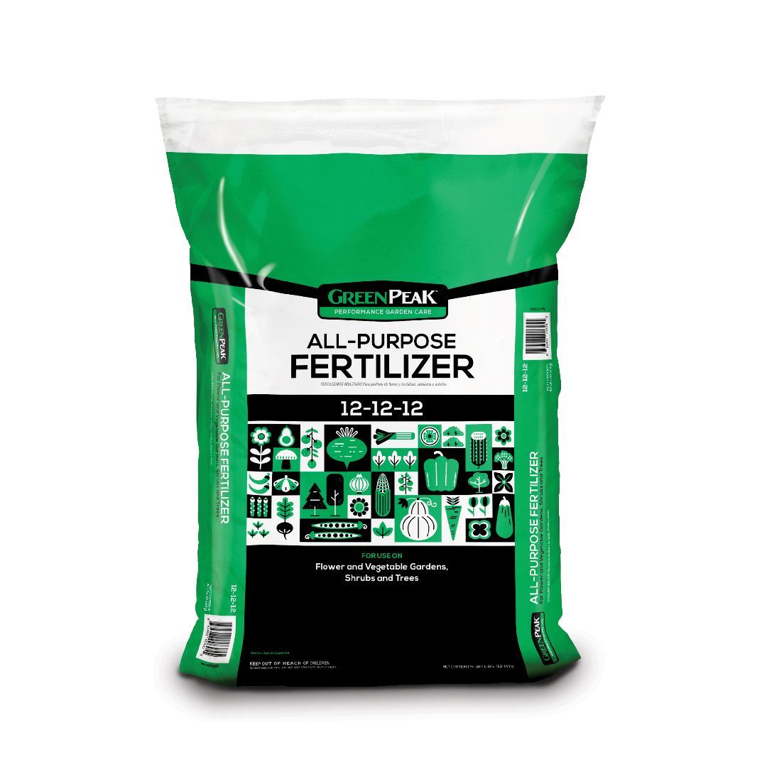 A white, black and green bag of green peak all purpose fertilizer 12-12-12 with veggies, flowers, shrubs, and trees 