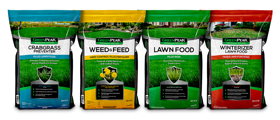 Bags of fertilizer lined up, representing the 4-app program of GreenPeak. Crabgrass, weed & feed, lawn food, and winterizer
