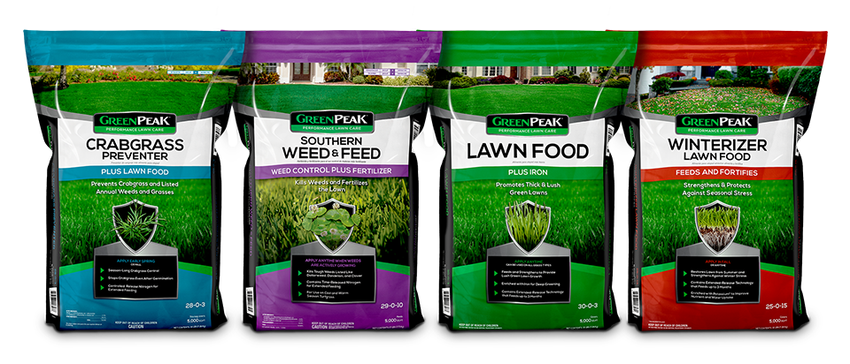 Bags of fertilizer lined up, representing the 4-app program of GreenPeak. Crabgrass, weed & feed, lawn food, and winterizer