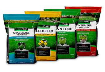 Bags of fertilizer lined up, representing the 4-app program of GreenPeak. Crabgrass, weed & feed, lawn food, and winterizer