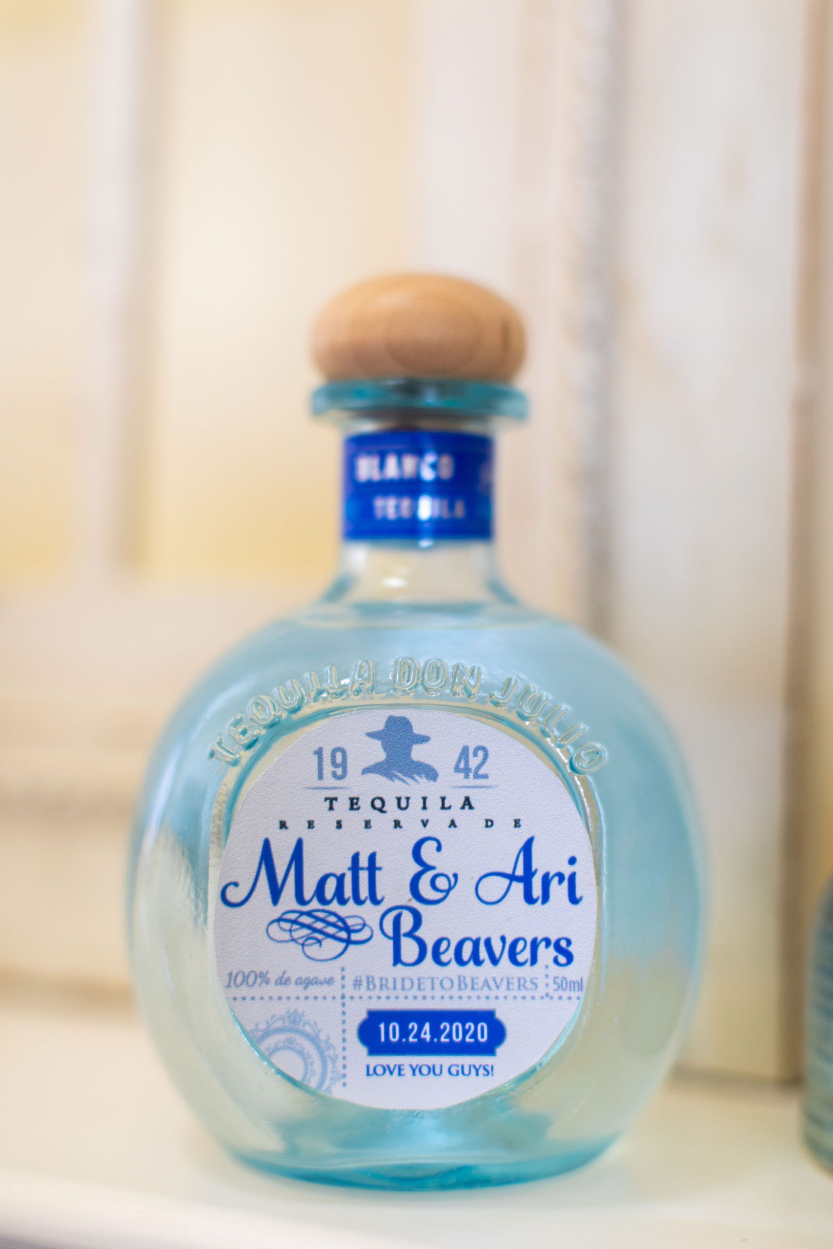 Teal tequila bottle with custom label 