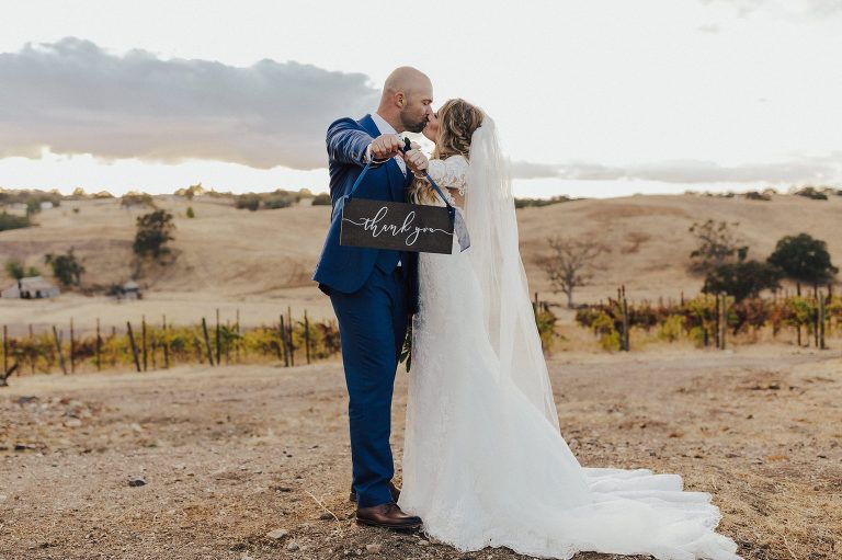 Newlyweds kissing, man holding 