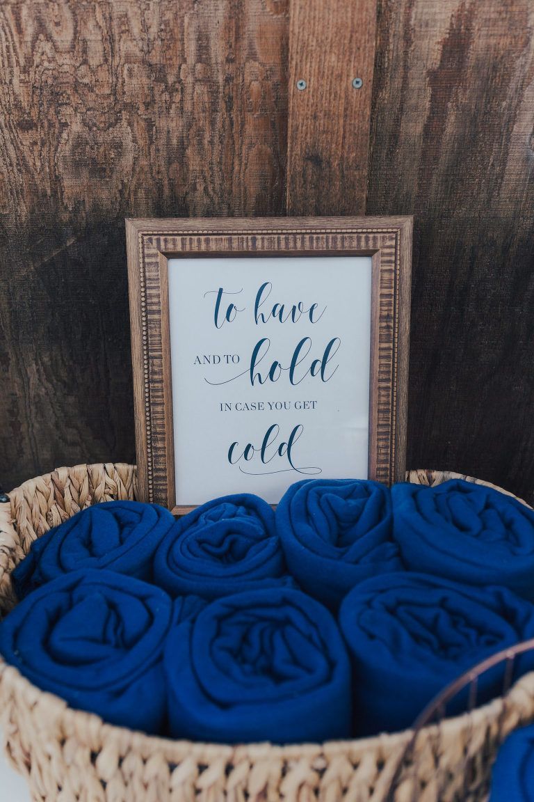 Basket of rolled blue blankets with framed sign: 