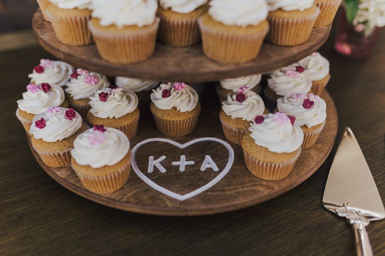Cupcake stand with two tiers of frosted cupcakes, heart shape with 
