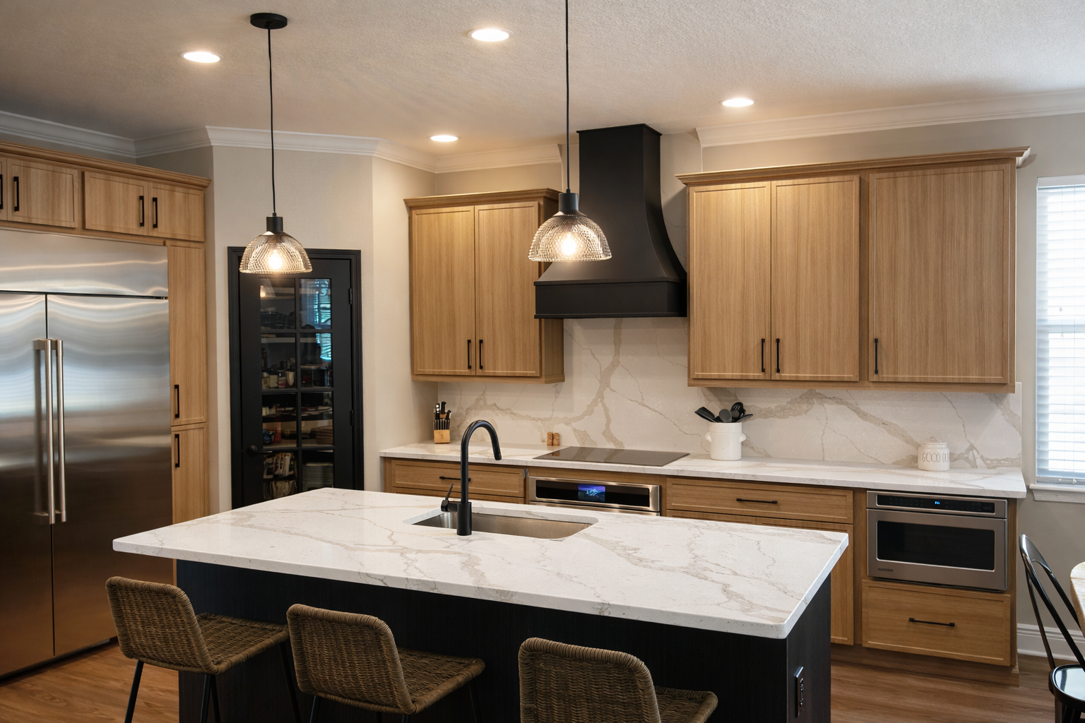 Modern kitchen with wood cabinets, black island, and stainless steel appliances.