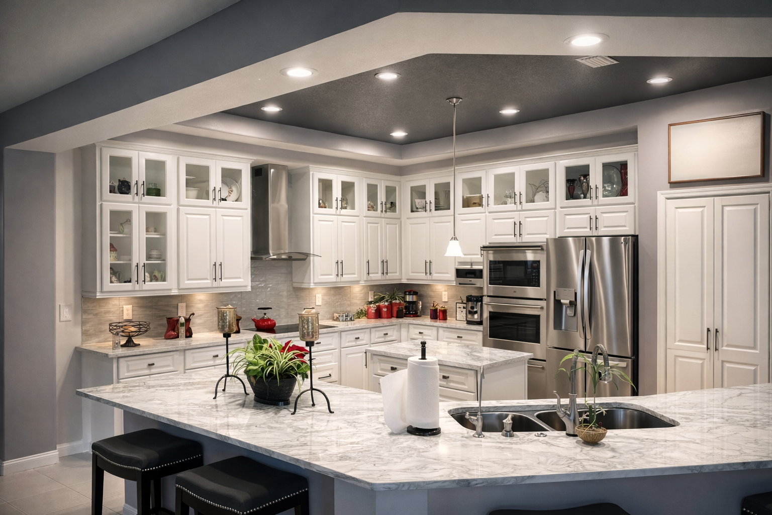 White modern kitchen with granite countertops, stainless steel appliances, and island with bar stools.
