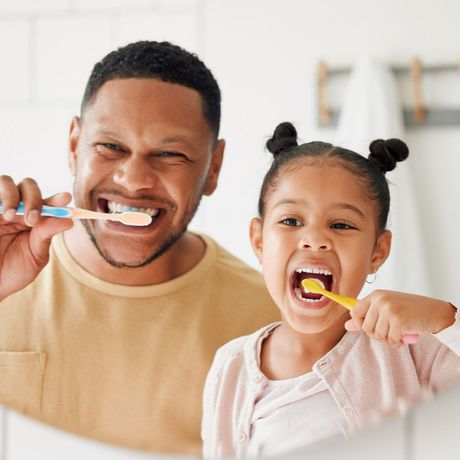 Father And Daughter Brushing Their Teeth — Melbourne, FL — Theodore G. Schropp, DDS Father And Daughter Brushing Their Teeth — Melbourne, FL — Theodore G. Schropp, DDS