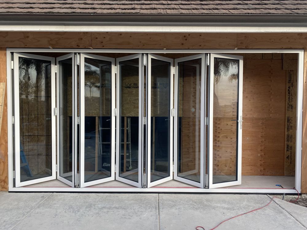 Open folding glass doors on a residential garage or storefront opening
