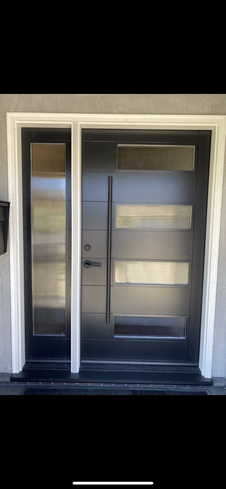 Front entrance with white double door, one frosted glass panel and one black door with horizontal glass windows.