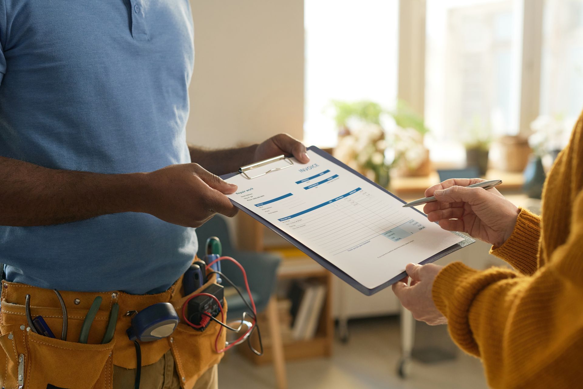 A man is giving a clipboard to a woman