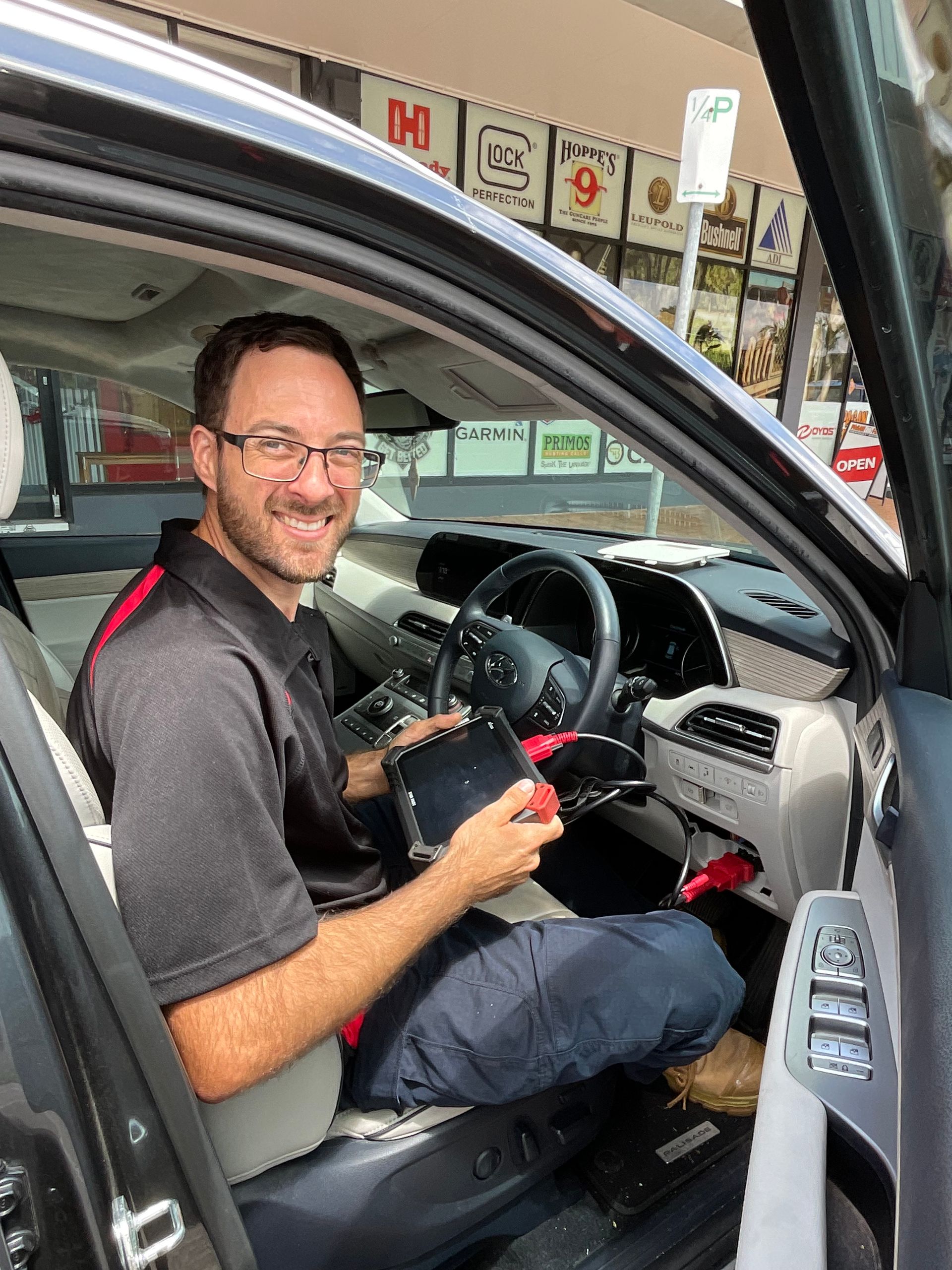 Locksmith opening lock on red car — Lock It Up Townsville In Aitkenvale, QLD