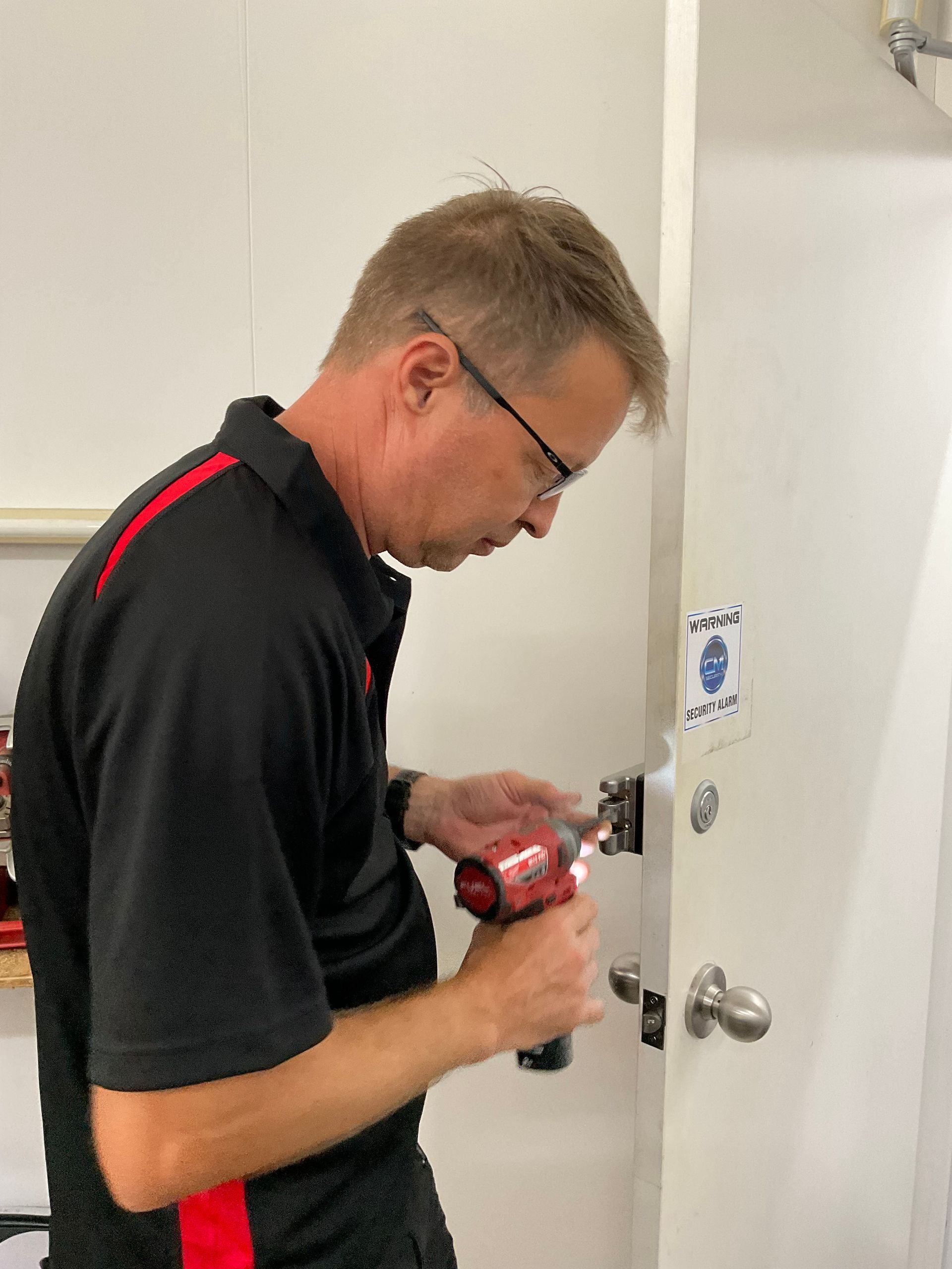 A Man Is Working On A Lock — Lock It Up Townsville In Aitkenvale, QLD