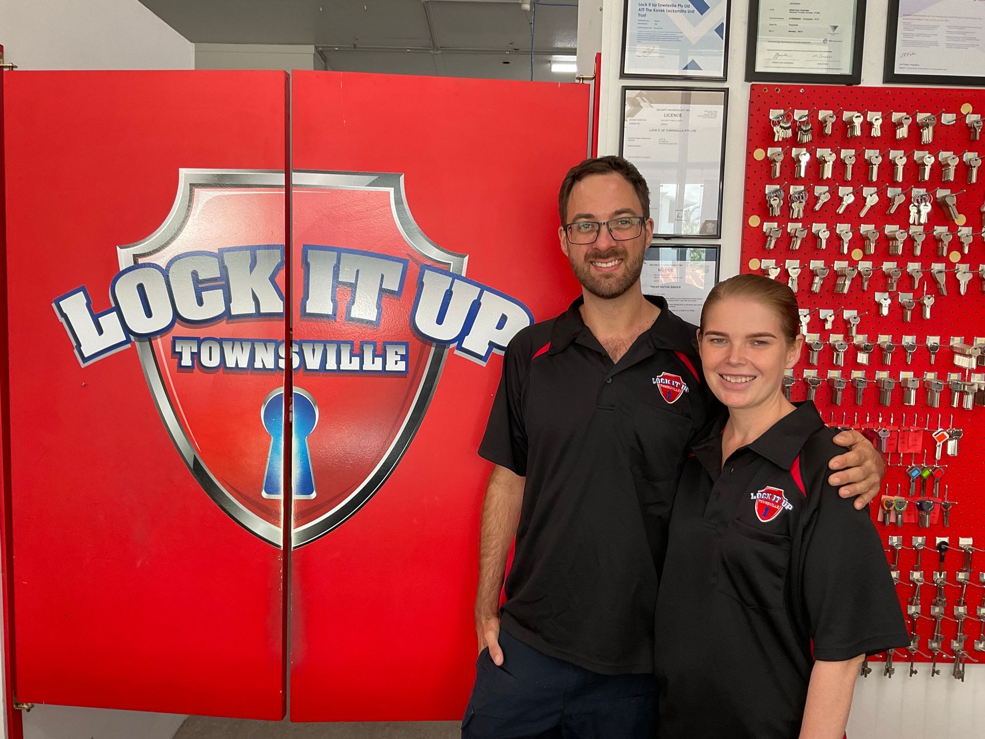 Worker Installing Lock on Screen Door — Lock It Up Townsville In Aitkenvale, QLD