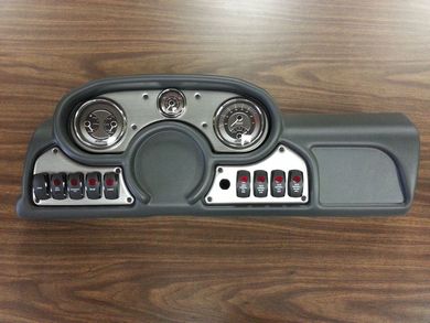Gray instrument panel with gauges, switches and center display