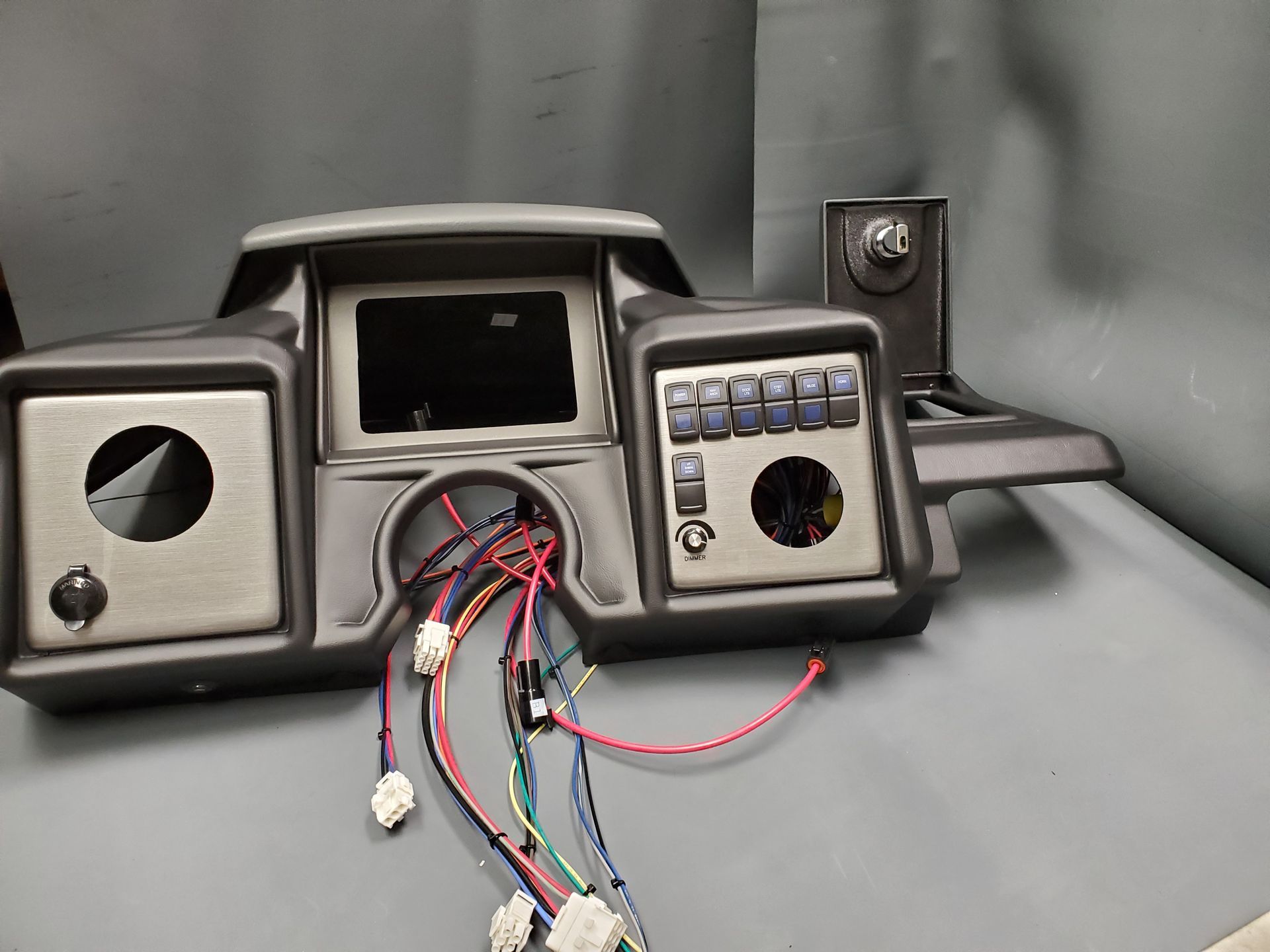 Boat dashboard panel with gauges and wiring harness installed by Uniforce