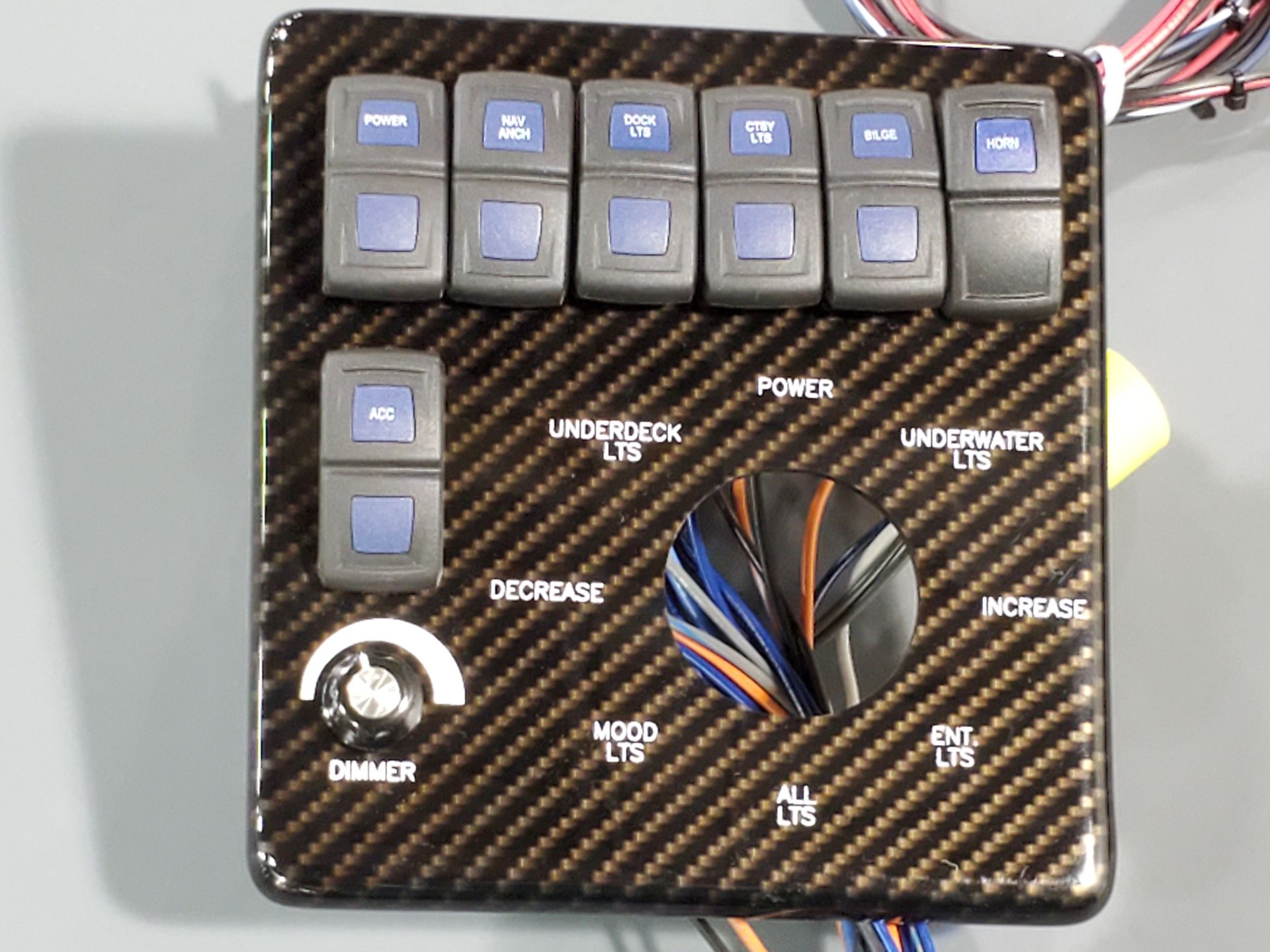 Carbon-look switch panel with backlit buttons, rotary knob and wiring