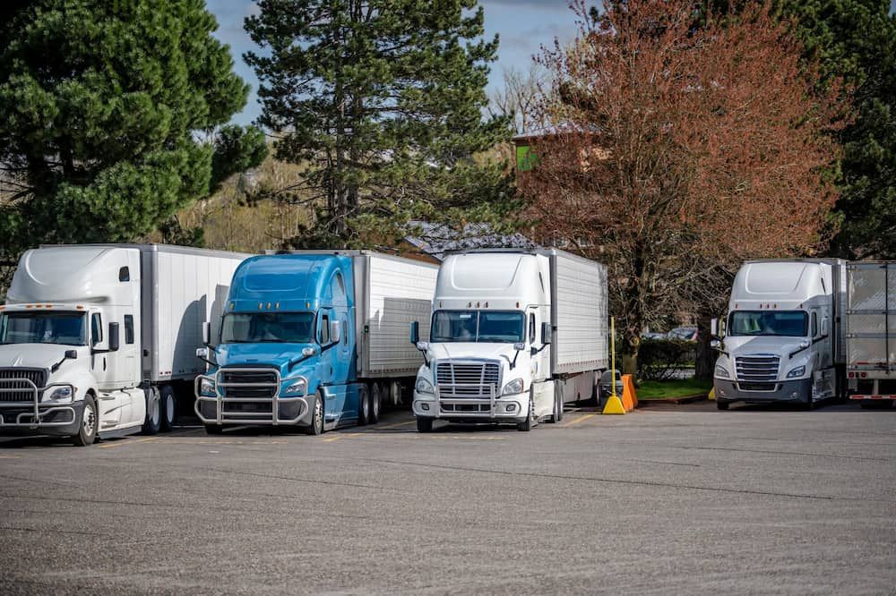 A Row of Semi Trucks Are Parked in a Parking Lot — Chaffey Power in Gladstone, QLD