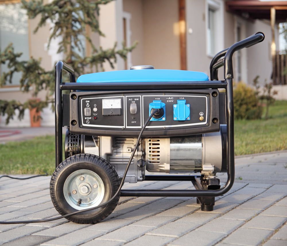 A Portable Generator is Sitting on a Sidewalk in Front of a House — Chaffey Power in West Mackay, QLD