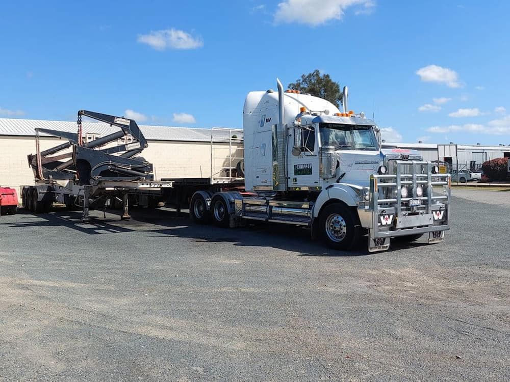 A Semi Truck With a Trailer Attached to It is Parked in a Parking Lot — Chaffey Power in West Mackay, QLD