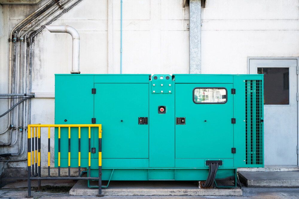 A Large Green Generator is Sitting Outside of a Building — Chaffey Power in Rockhampton, QLD