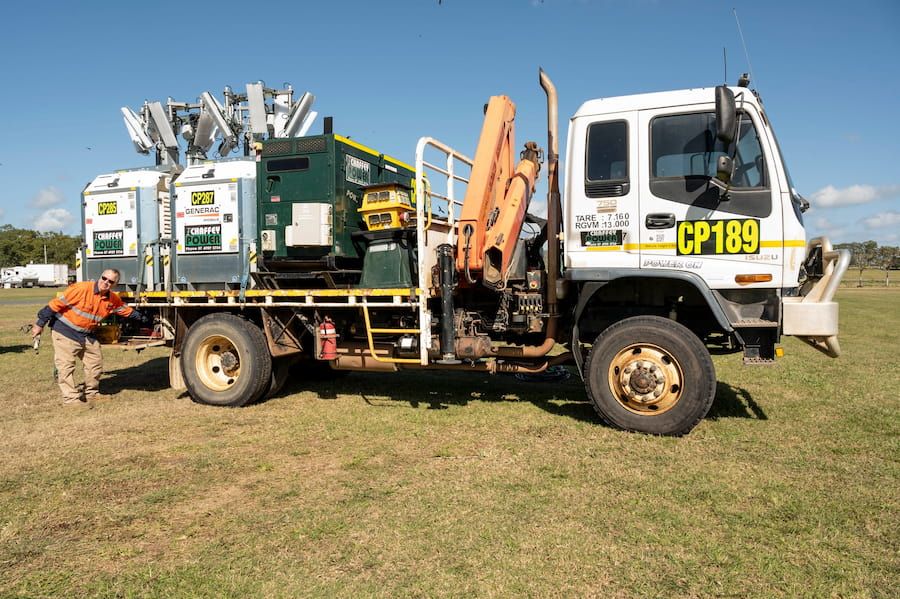 A White Truck With the Number Cp189 on the Side is Parked in a Grassy Field — Chaffey Power in West Mackay, QLD