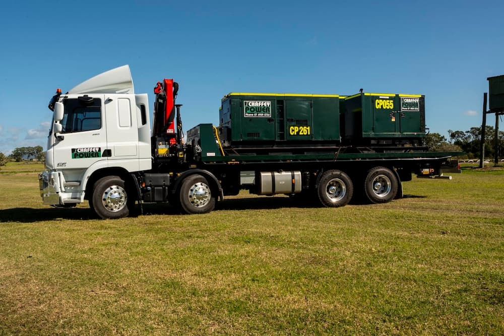 A Large Truck is Parked in a Grassy Field — Chaffey Power in Townsville, QLD
