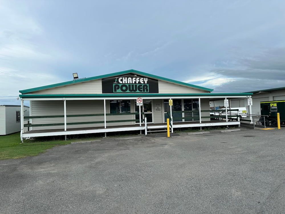 A Large White Building With a Green Roof and a Porch — Chaffey Power in West Mackay, QLD