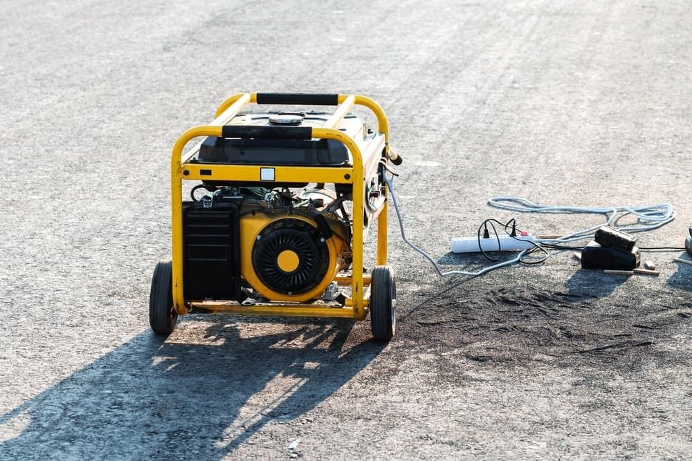 A Yellow Generator is Sitting on the Ground in a Parking Lot — Chaffey Power in Townsville, QLD