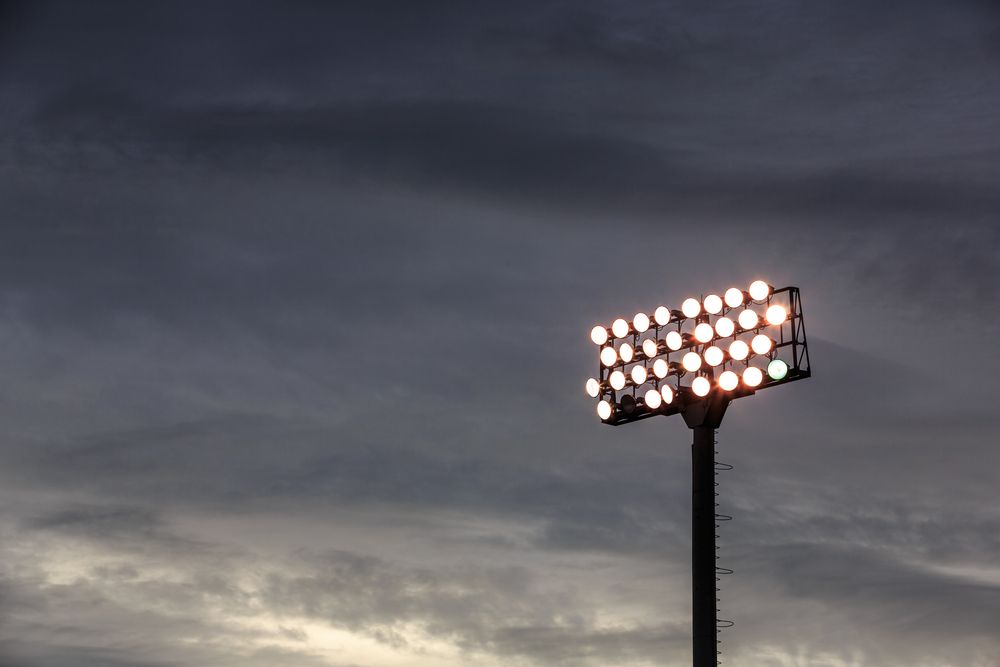 A Stadium Light is Lit Up at Night Against a Cloudy Sky — Chaffey Power in West Mackay, QLD