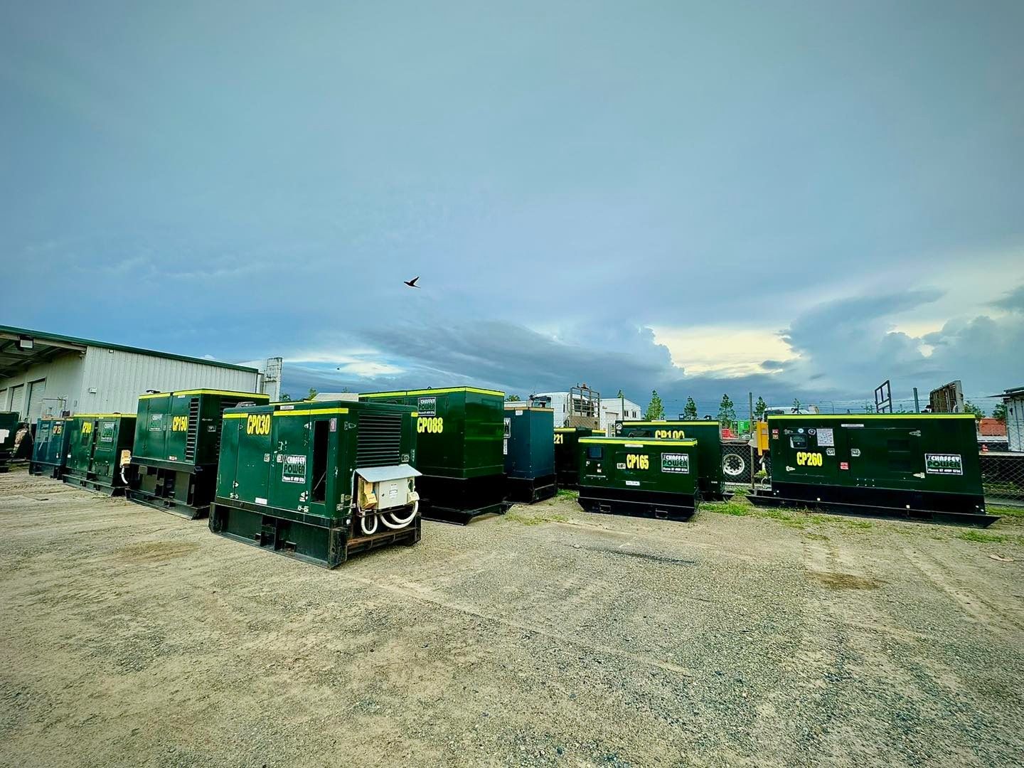 A bunch of green generators in a yard ready for equipment hire in Mackay — Chaffey Power in West Mackay, QLD