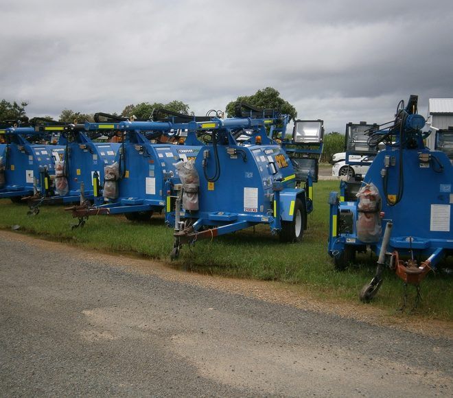 A Row of Blue Trailers Are Parked on the Side of the Road — Chaffey Power in West Mackay, QLD