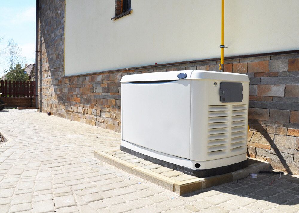 A White Generator is Sitting on the Side of a Building — Chaffey Power in Rockhampton, QLD
