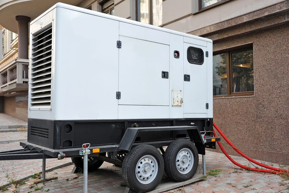 A Generator on a Trailer is Parked in Front of a Building — Chaffey Power in Moranbah, QLD