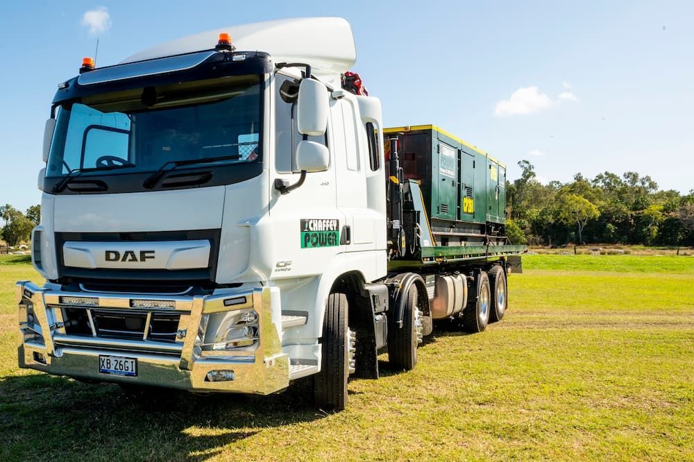 A White Daf Truck is Parked in a Grassy Field — Chaffey Power in West Mackay, QLD
