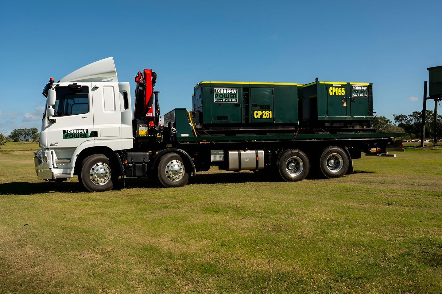 Truck Transporting Hired Industrial Generators On Flatbed Trailer