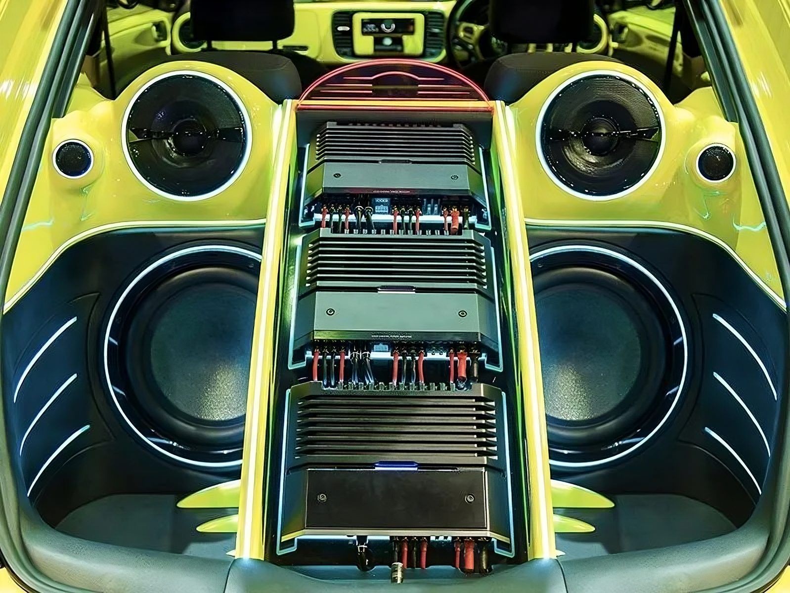 Lime green trunk build with two subwoofers, amplifier rack and matching panels