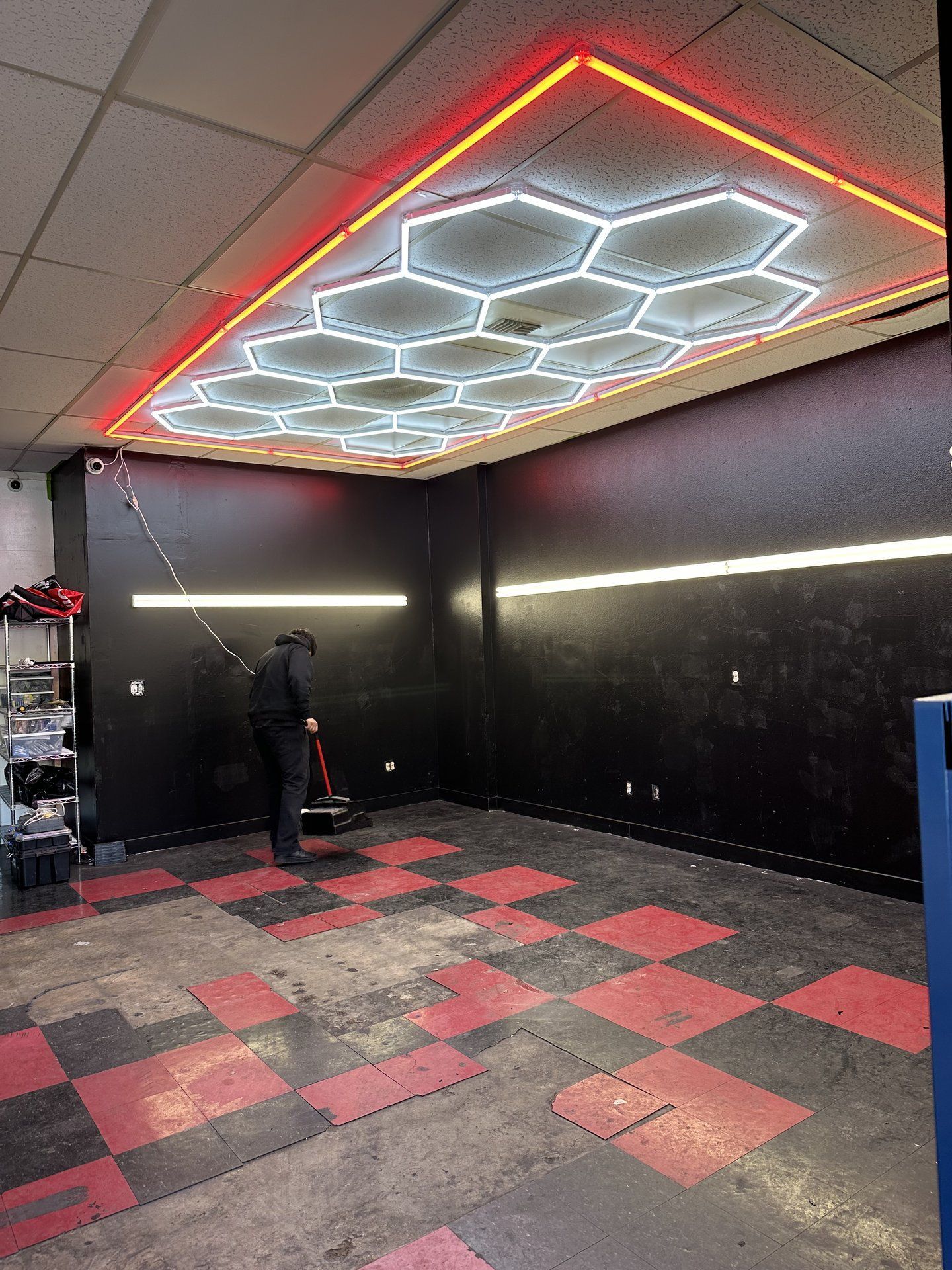 The West Coast tint bay with the hexagon lights on and the checkered floor