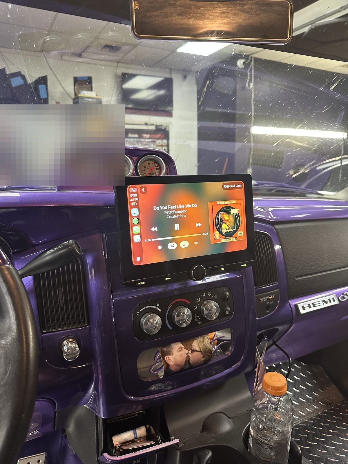 Purple Ram 1500 interior with a floating CarPlay touchscreen and a gauge pod